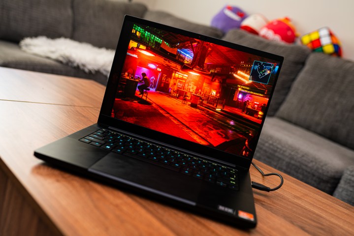 A Razer Blade 14 gaming laptop on a coffee table.