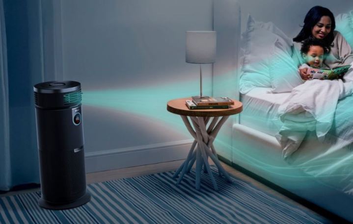 A black Shark air purifier in a bedroom with a mother and her baby.