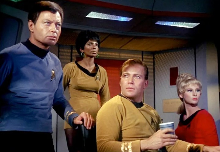The Enterprise crew looks alarmed in Star Trek.