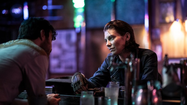 Maggie sitting in a bar having a drink in a scene from Walking Dead: Dead City.
