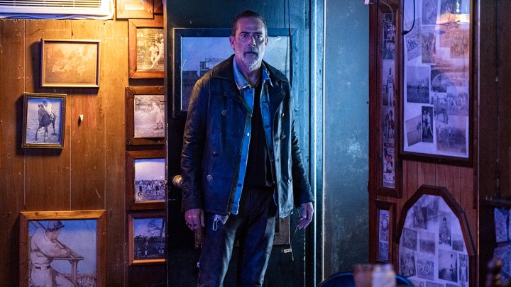 Negan looking surprised standing in a bar in a scene from The Walking Dead: Dead City.