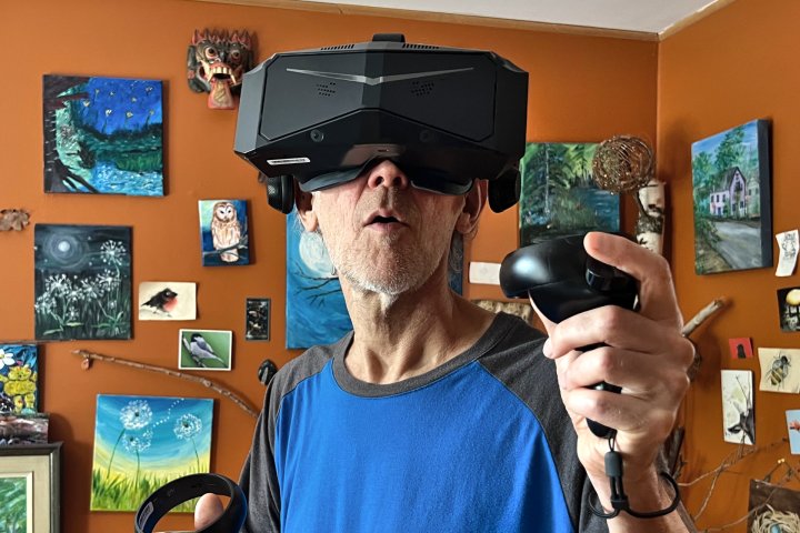 Alan Truly wears the Pimax Crystal, a premium VR headset with incredible sharpness.