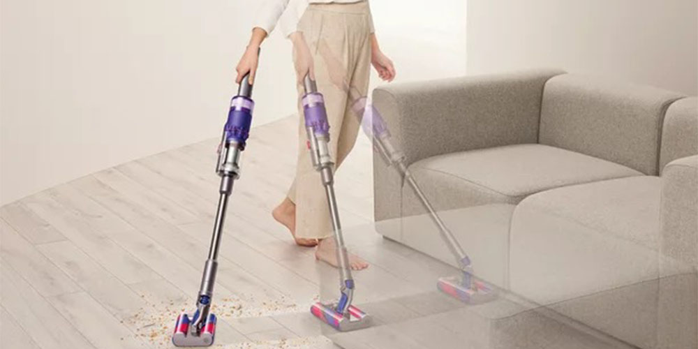 The Dyson Omni-Glide Cordless Vacuum being used in a clean living room.