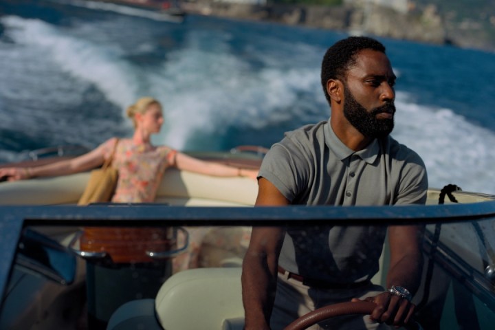 John David Washington drives Elizabeth Debicki on a boat in Tenet.