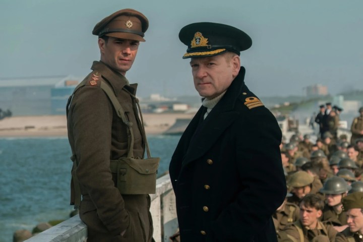 Kenneth Branagh and James D'Arcy stand on a pier together in Dunkirk.