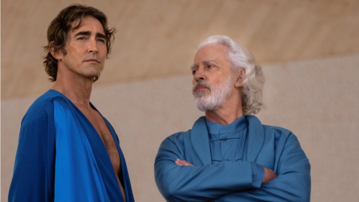 Lee Pace stares into the distance while another man looks at him in Foundation.