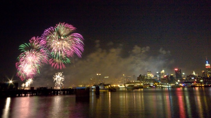 Fireworks explode over the New York City skyline.