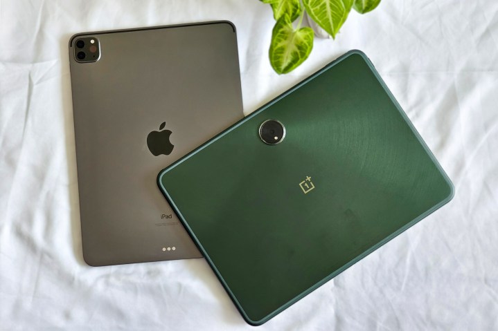 Green OnePlus Pad Android tablet on top of space gray 11-inch M1 iPad Pro 2021.