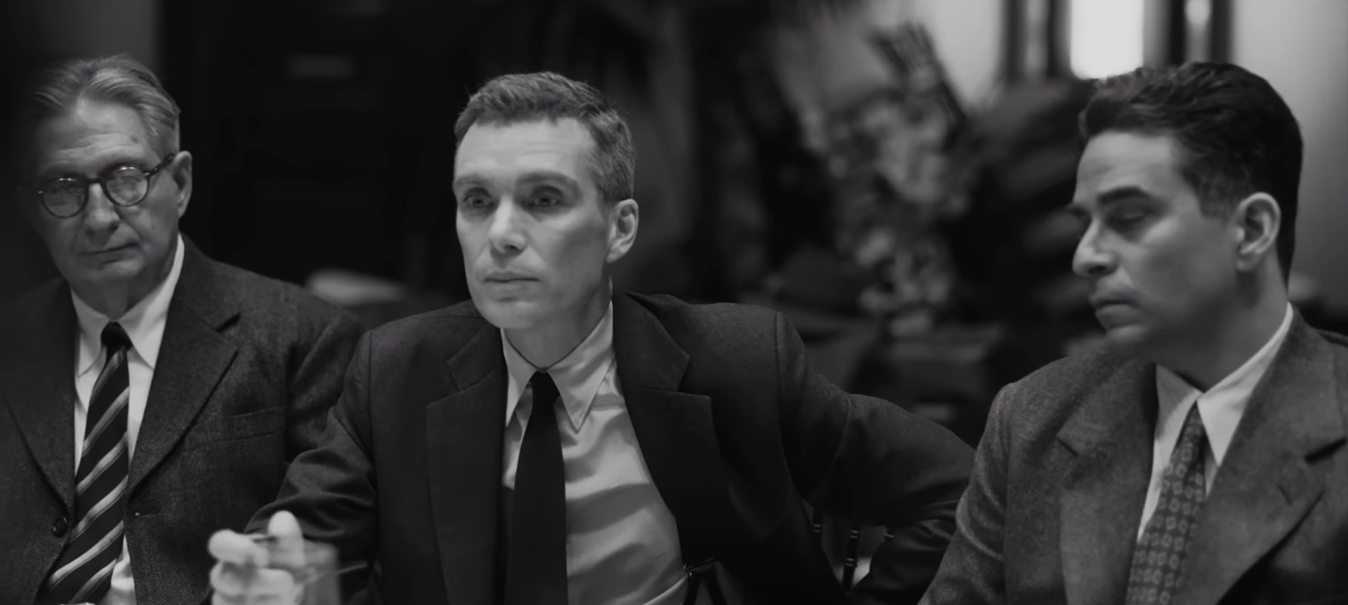 A black and white shot of Oppenheimer and two men in "Oppenheimer."