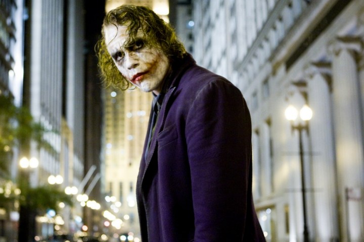 The Joker stands on the street in The Dark Knight.