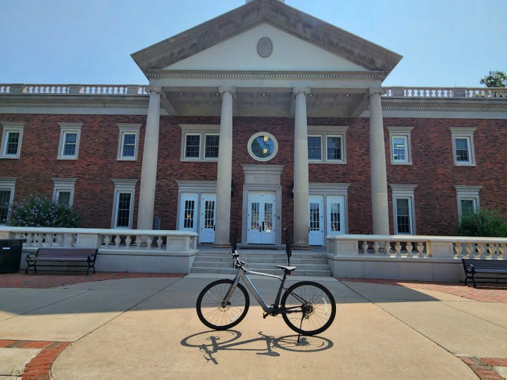 velotric t1 e bike review parked in front of a federal style new england town hall