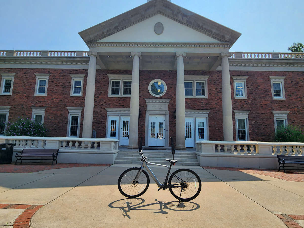 Velotric T1 parked in front of a Federal style New England town hall