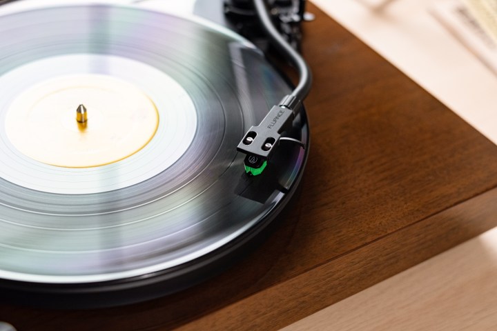 A close-up of the Fluance RT81+ turntable in walnut.