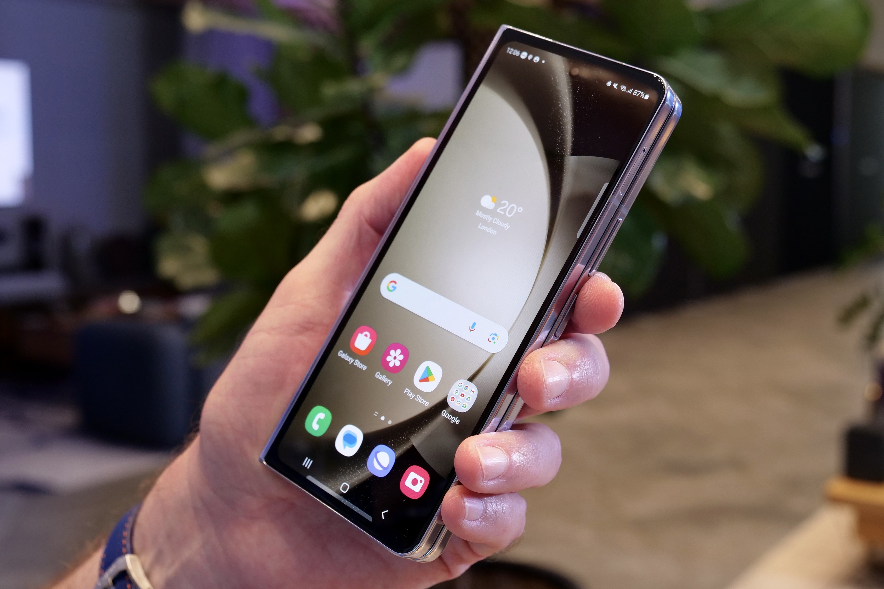 A person holding the closed Samsung Galaxy Z Fold 5.