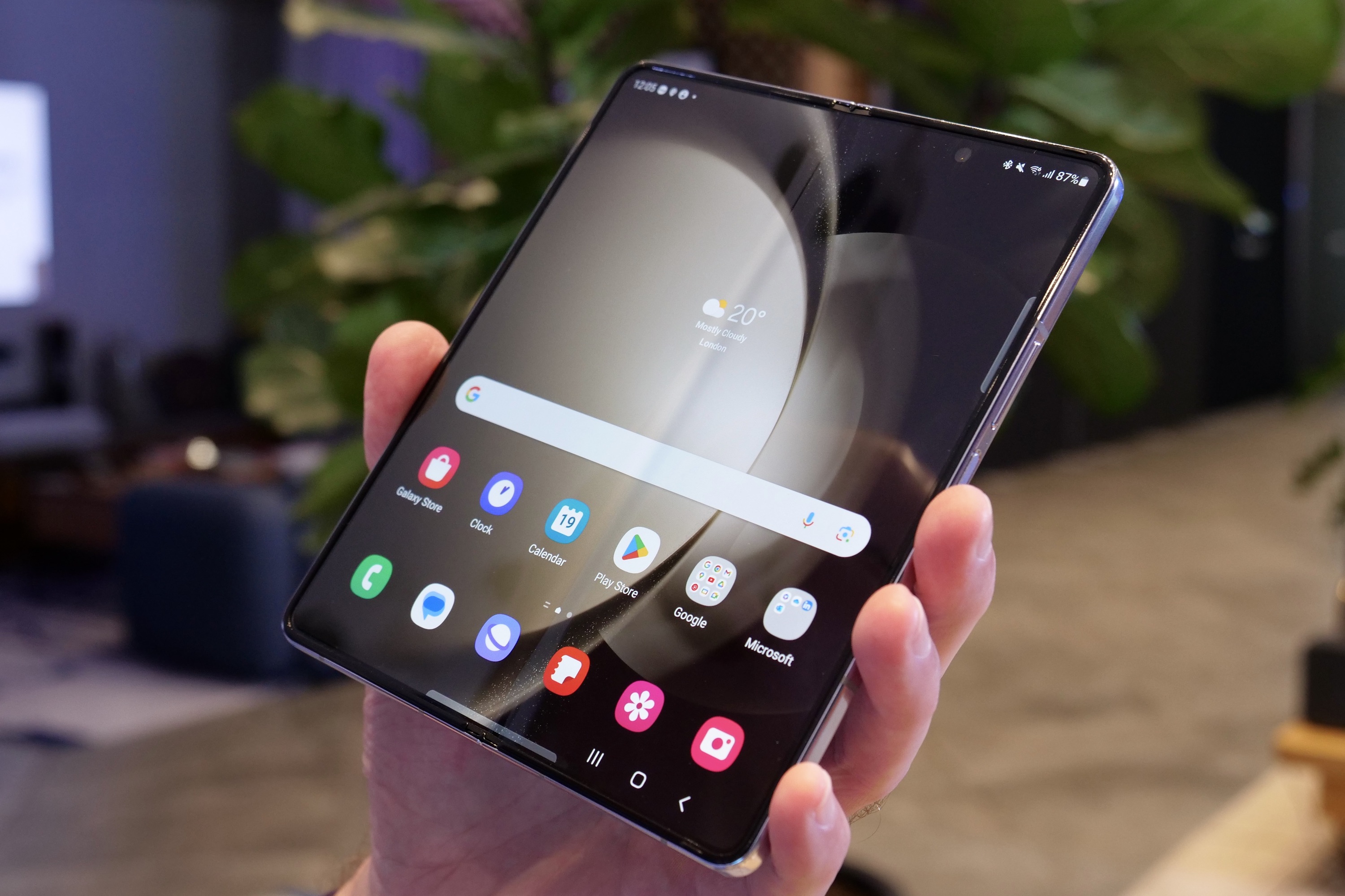 A person holding the open Samsung Galaxy Z Fold 5.