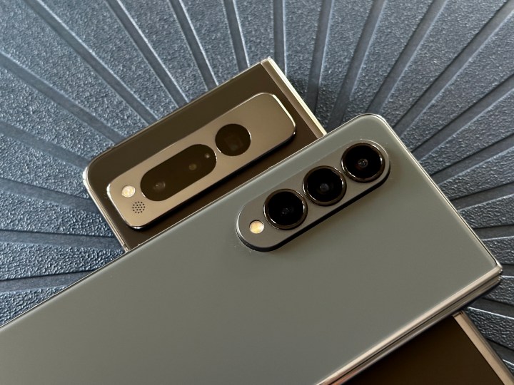 A Samsung Galaxy Z Fold 4 on top of a Google Pixel Fold, showing the cameras on both phones.