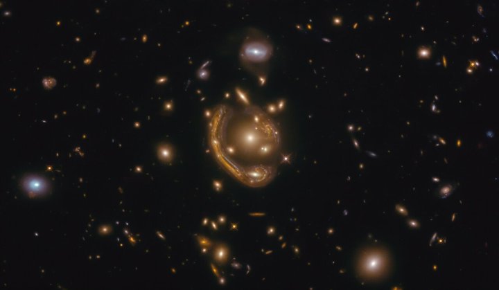 An image taken from the Hubble Space Telescope shows the distortion of "gravitational lensing," which reveals the effects of dark matter, even though we can't see it.