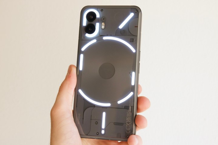 The back of the Nothing Phone 2 with its Glyph lights on.