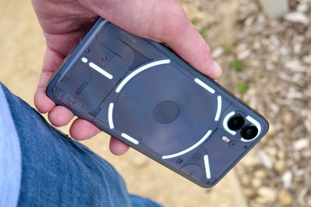 A person holding the Nothing Phone 2, with the lights active.