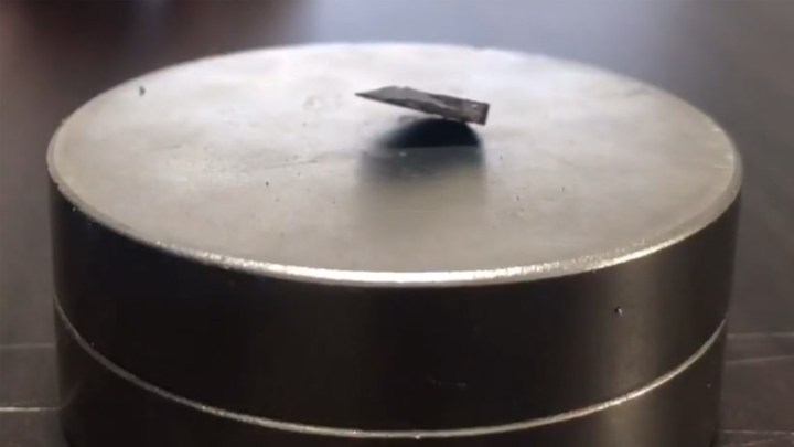 An alleged superconductive material levitating over a magnet.