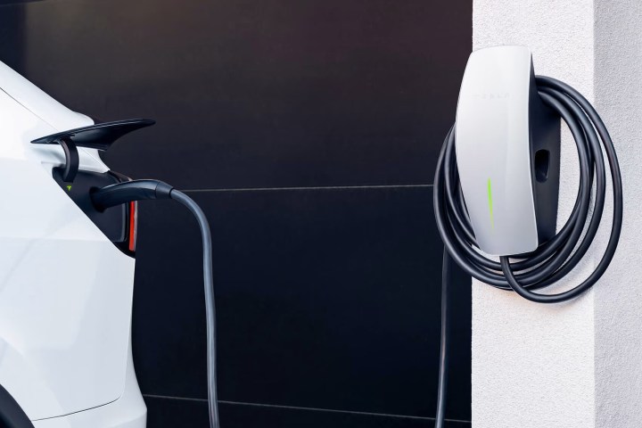 A Tesla Wall charger connects to a Model X via the NACS connector style.