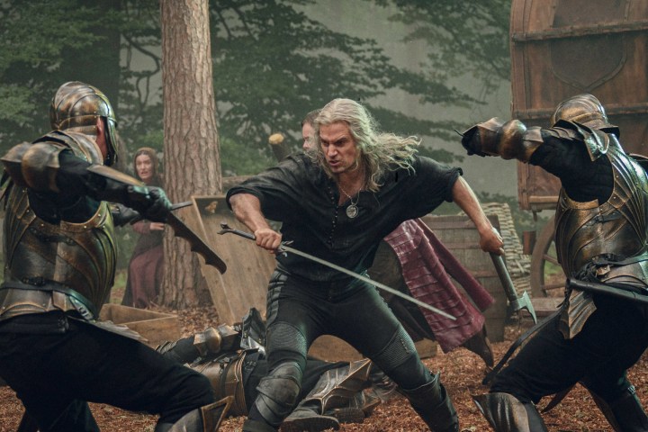 Geralt battles soldiers in the woods in The Witcher season 3.