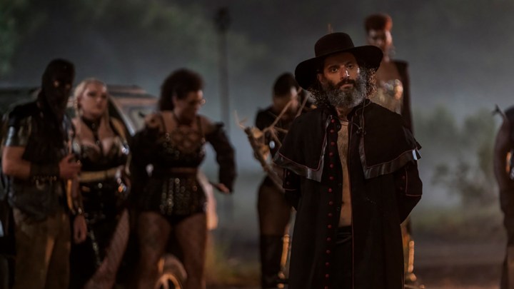 The Preacher with his army behind him in a scene from Twisted Metal.
