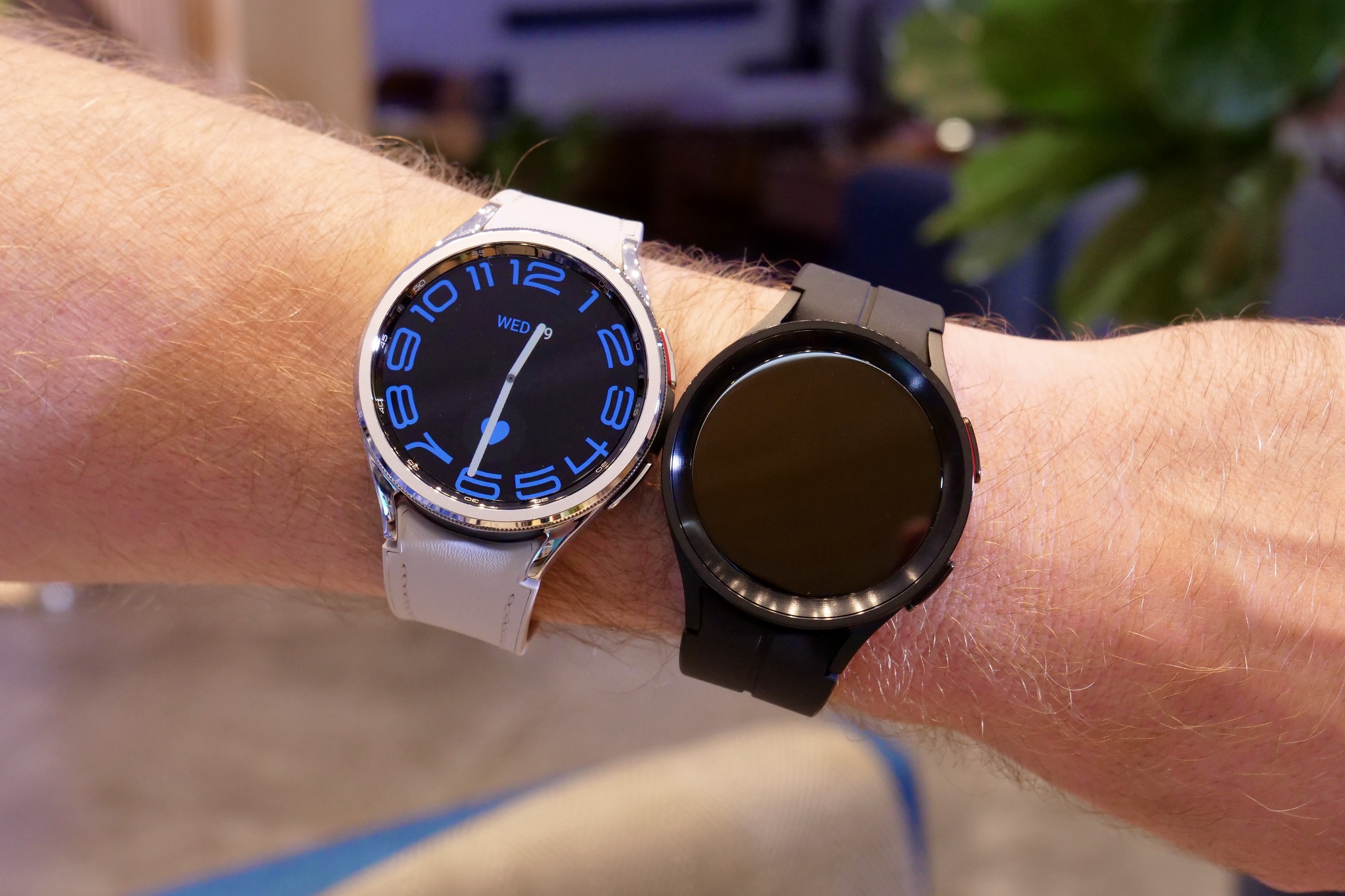 The Samsung Galaxy Watch 6 Classic and Galaxy Watch 5 Pro, side by side on a persons wrist.