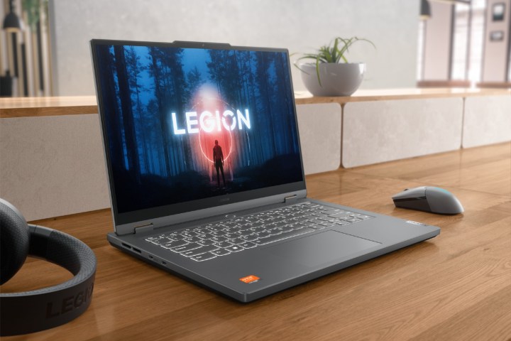 The Legion Slim 5 14 on a desk with peripherals on it.
