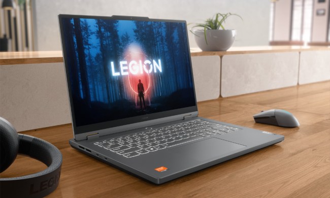 The Legion Slim 5 14 on a desk with peripherals on it.