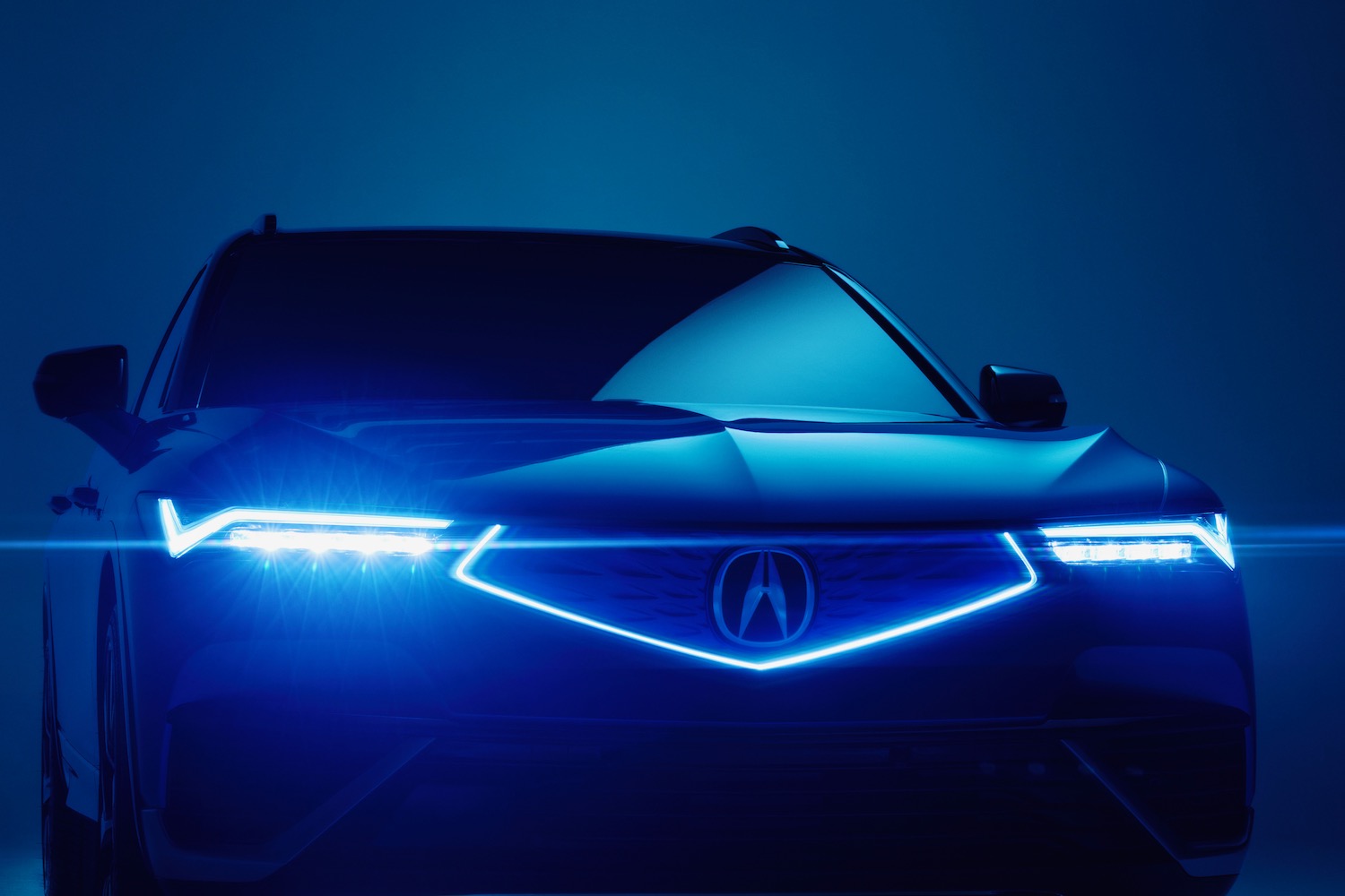 The 2024 Acura ZDX in the dark with its headlights on.