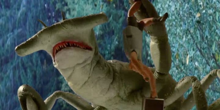 A shark monster holds a victim in Cocaine Shark