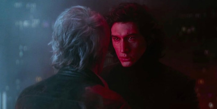 Adam Driver stands and stares at Harrison Ford in Star Wars: The Force Awakens.