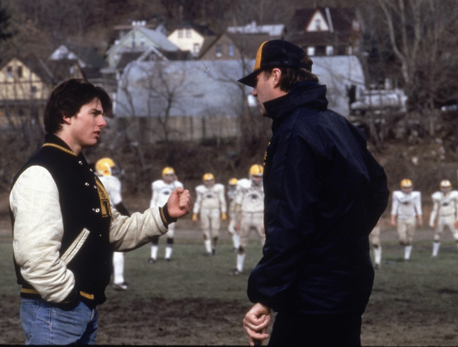 A football player talks to a football coach on the field in All The Right Moves.