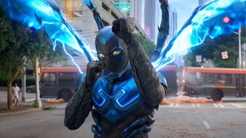Blue Beetle unleashes his wings in a still from Blue Beetle.