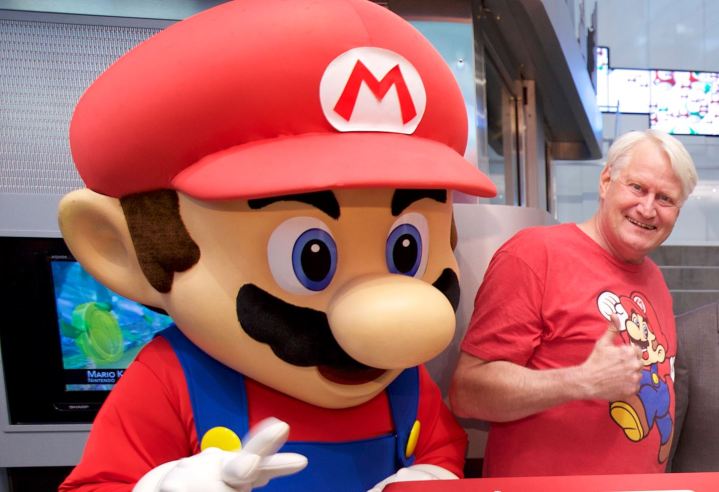 Charles Martinet stands with someone in a Mario costume.