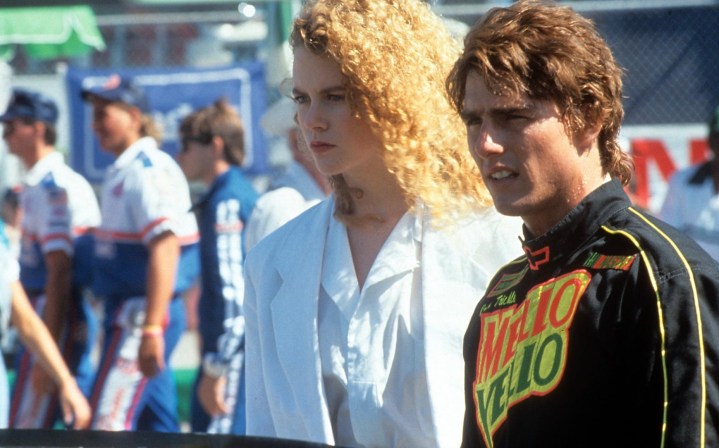 Nicole Kidman and Tom Cruise stand beside one another in Days of Thunder.