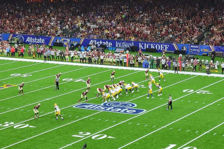 Florida State and LSU players on the field playing a football game.