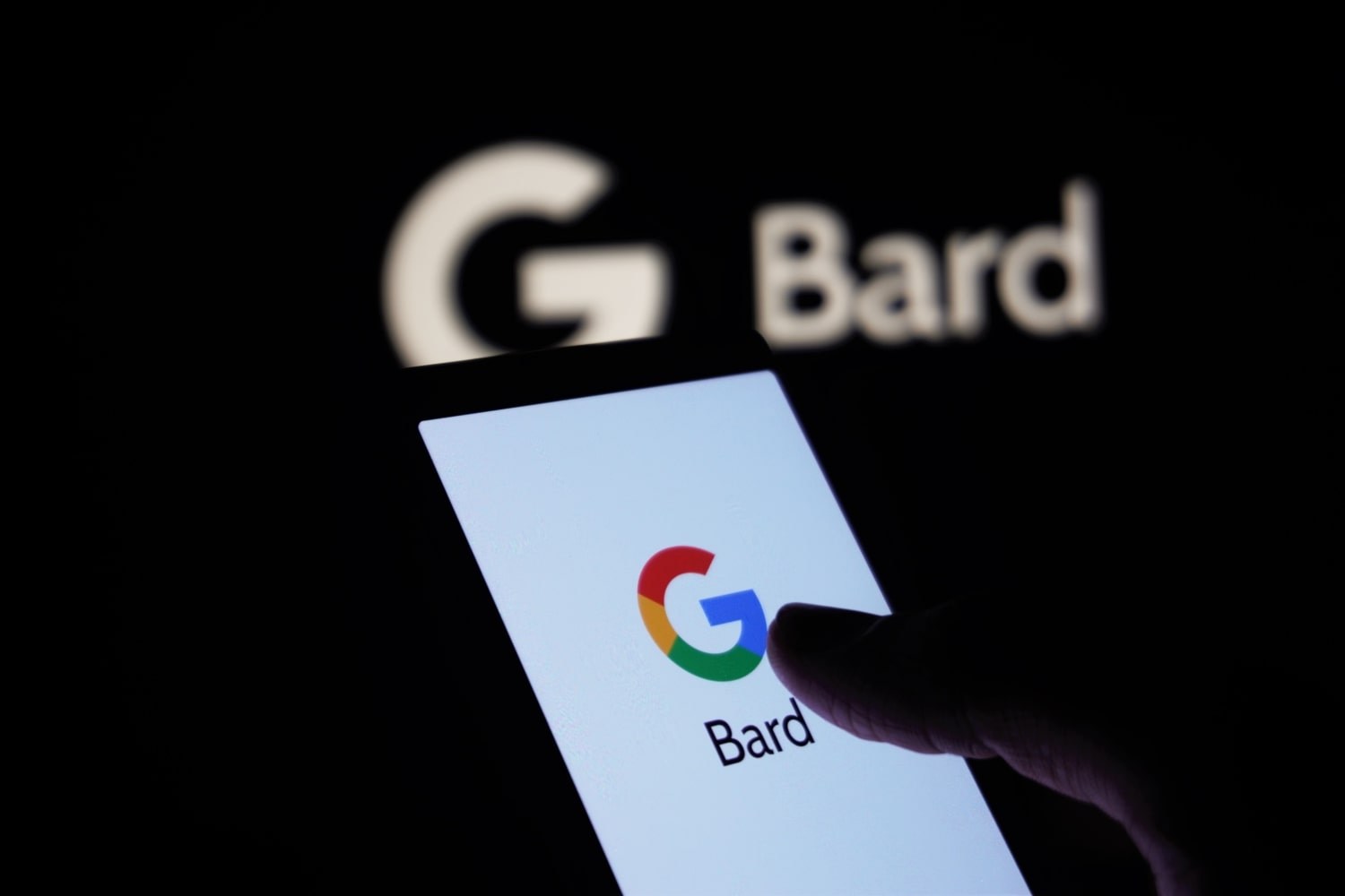 A person holds a phone with the Google logo and word 'Bard' on the screen. In the background is a Google Bard logo.