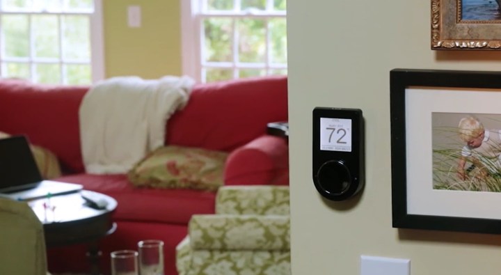 The Lux Geo smart thermostat installed in a home.