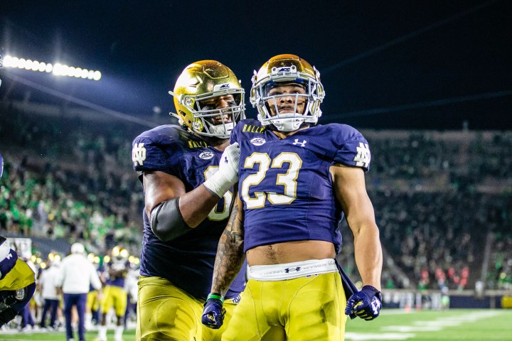 Two Notre Dame football players celebrate.