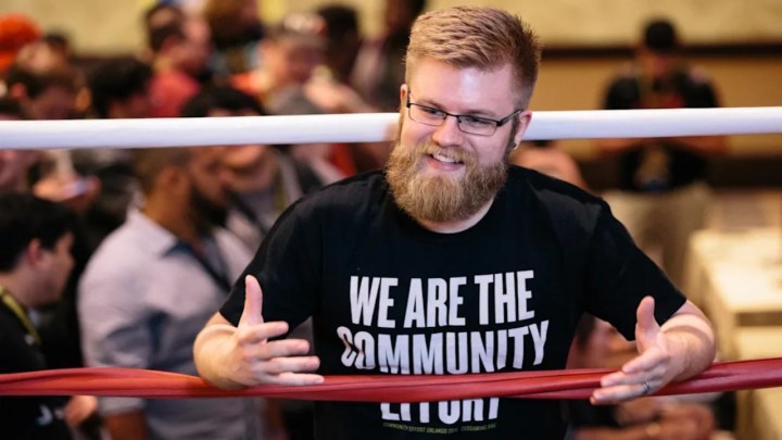 Rick Thiher standing in a wrestling ring at fighting game tournament, CEO