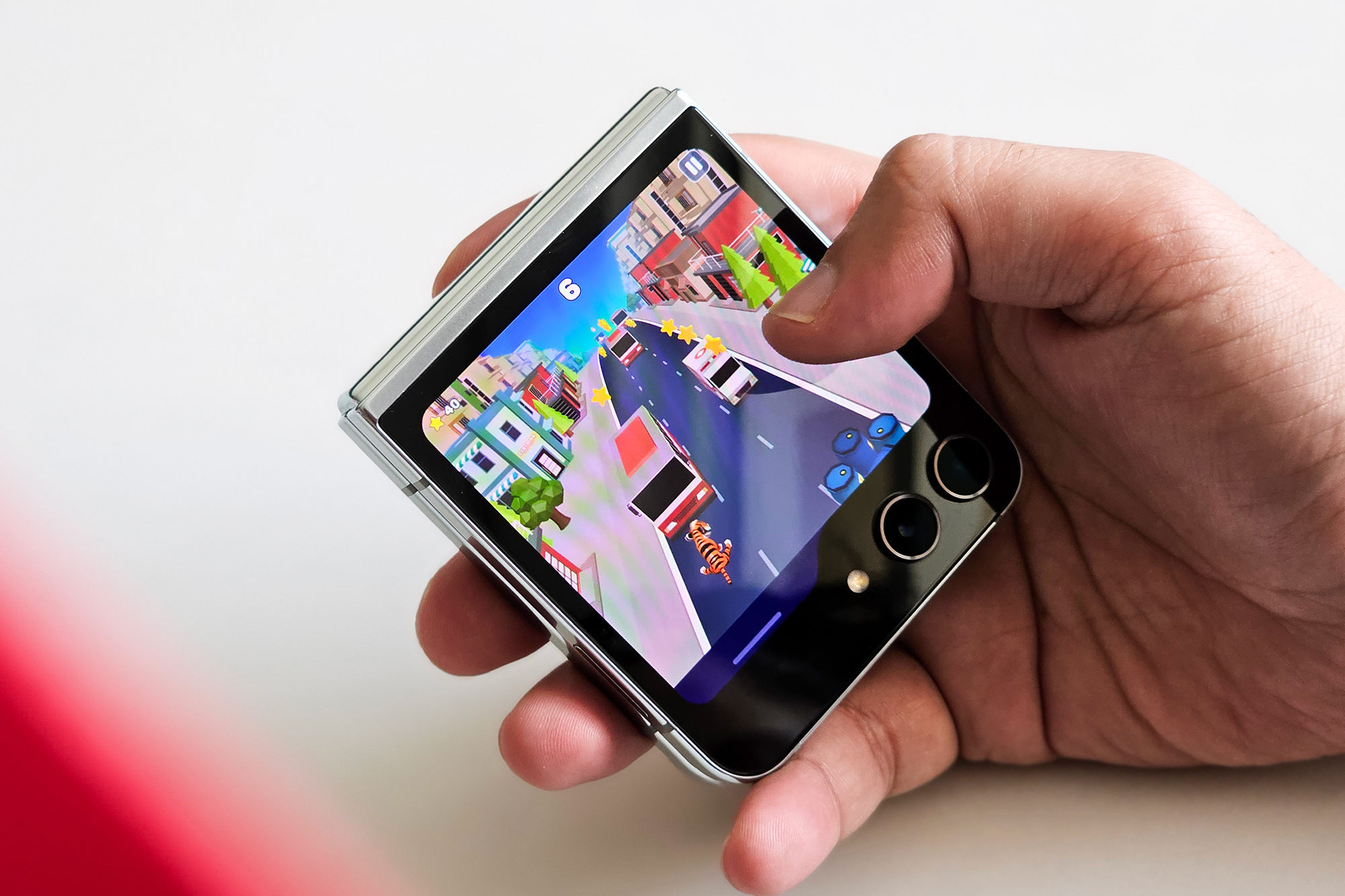 Google GameSnack Tiger Run mini Android game on Samsung Galaxy Z Flip 5 cover screen.