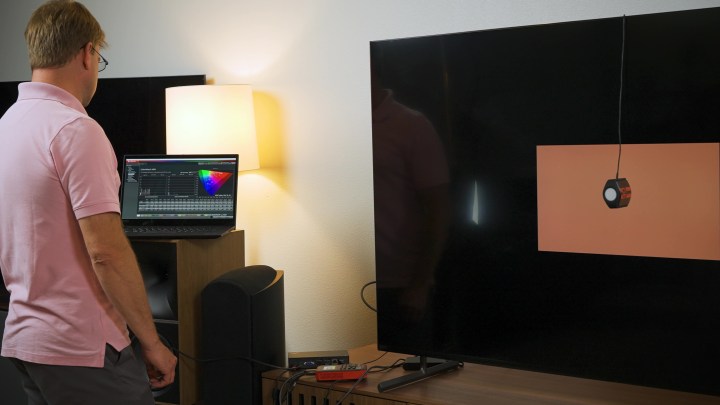 A man measures color accuracy on the Sony X90L. 