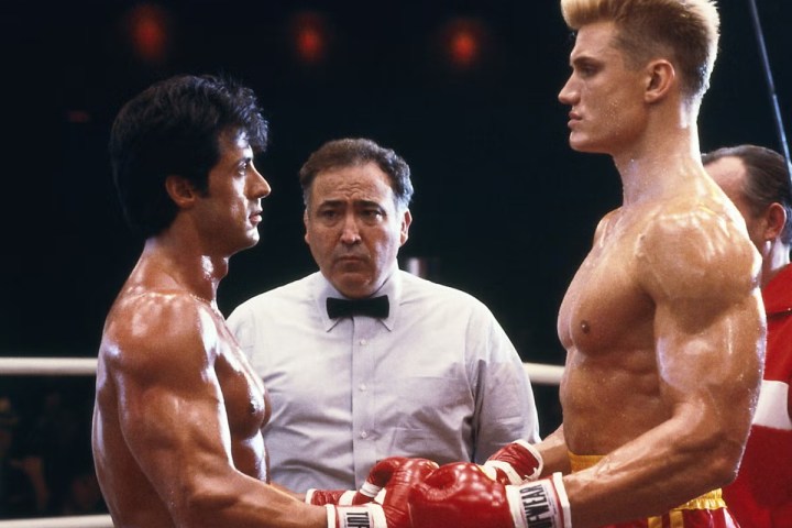 Sylvester Stallone and Dolph Lundgren touch gloves in Rocky 4.
