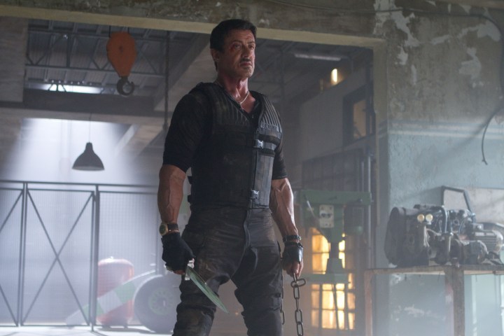 Sylvester Stallone holds a knife and chain in The Expendables 2.