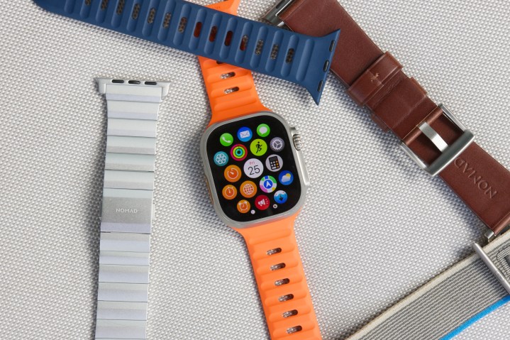 Apple Watch Ultra surrounded by multiple watch bands.