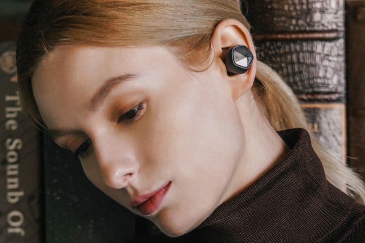Woman wearing Astell&Kern UW100 MK II wireless earbuds.