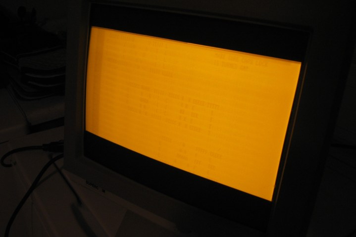 Phosphor burn-in ("screen burn") visible on an amber monochrome CRT computer monitor.