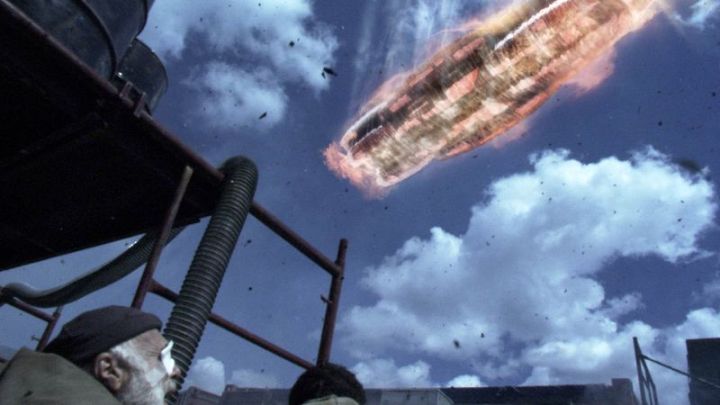 The Battlestar Galactica falls out of the skies of New Caprica, burning red from atmospheric friction, in the episode "Exodus, Part 2"